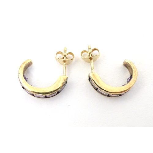 729 - A pair of 9ct gold earrings set with amethyst.