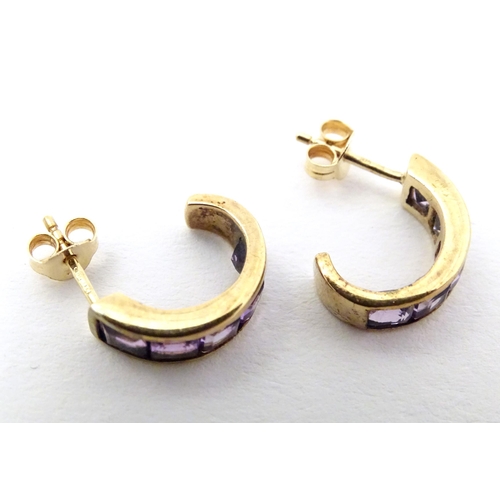 729 - A pair of 9ct gold earrings set with amethyst.