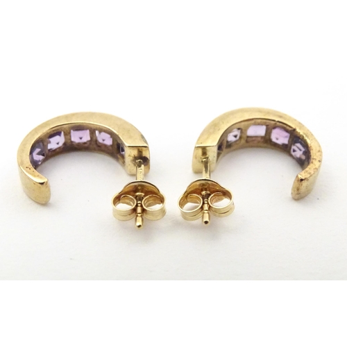 729 - A pair of 9ct gold earrings set with amethyst.