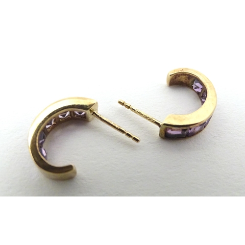 729 - A pair of 9ct gold earrings set with amethyst.