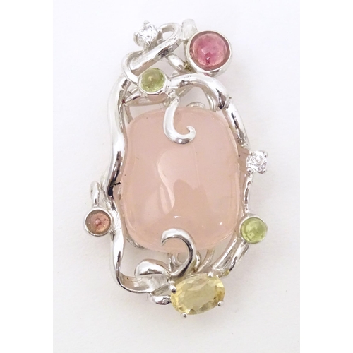 733 - A .925 silver pendant set with central rose quartz and various coloured stone. Approx. 1 3/4