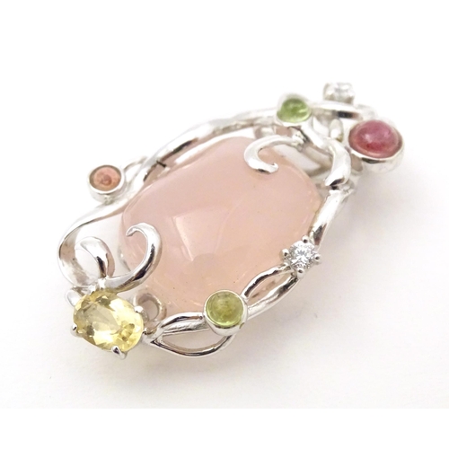 733 - A .925 silver pendant set with central rose quartz and various coloured stone. Approx. 1 3/4