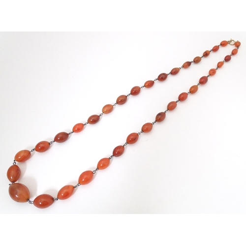 750 - A white metal necklace of graduated carnelian stone beads. Approx. 30