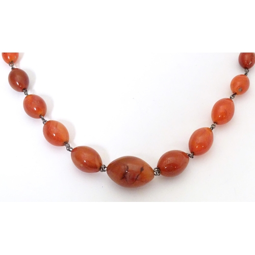 750 - A white metal necklace of graduated carnelian stone beads. Approx. 30