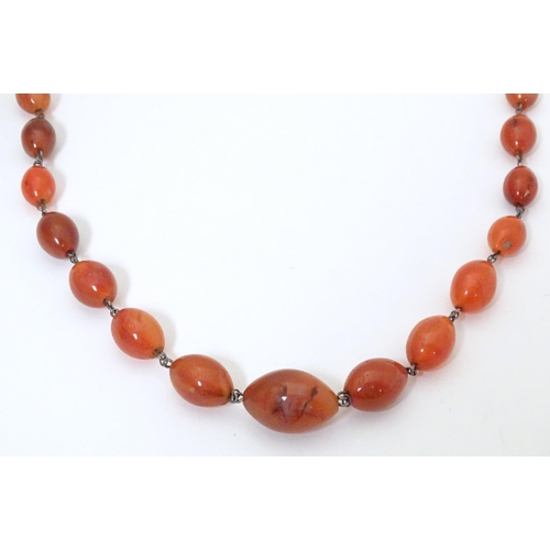 750 - A white metal necklace of graduated carnelian stone beads. Approx. 30