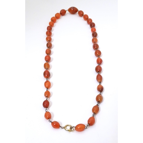 750 - A white metal necklace of graduated carnelian stone beads. Approx. 30