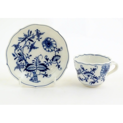 101 - A Meissen blue and white cup and saucer in the onion pattern. With blue crossed sword mark under. Cu... 