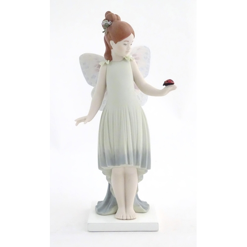 117 - A Lladro figure modelled as a fairy holding a ladybird / ladybug, Childhood Fantasy. Marked under, A... 