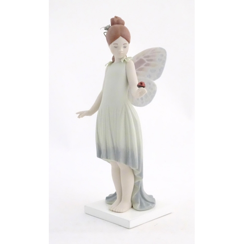 117 - A Lladro figure modelled as a fairy holding a ladybird / ladybug, Childhood Fantasy. Marked under, A... 