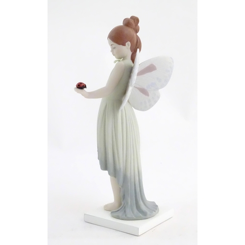 117 - A Lladro figure modelled as a fairy holding a ladybird / ladybug, Childhood Fantasy. Marked under, A... 