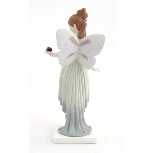 117 - A Lladro figure modelled as a fairy holding a ladybird / ladybug, Childhood Fantasy. Marked under, A... 