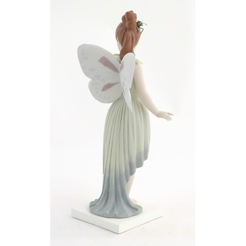 117 - A Lladro figure modelled as a fairy holding a ladybird / ladybug, Childhood Fantasy. Marked under, A... 