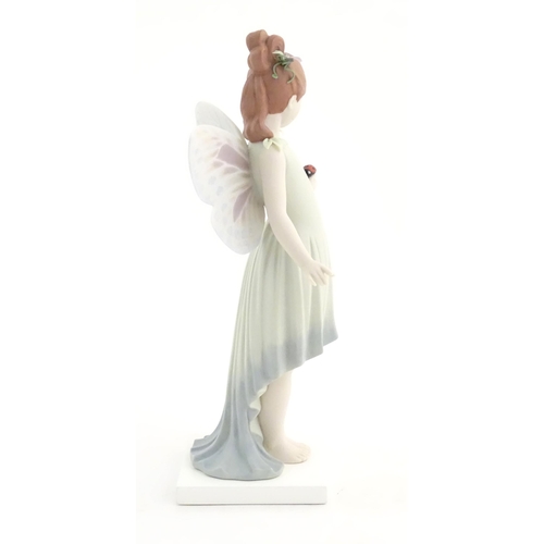 117 - A Lladro figure modelled as a fairy holding a ladybird / ladybug, Childhood Fantasy. Marked under, A... 