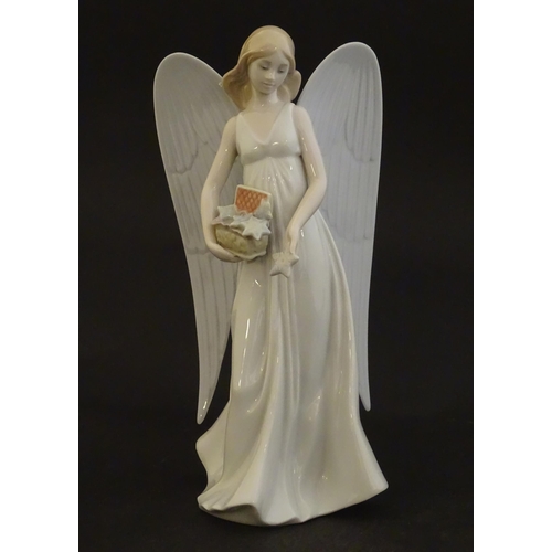 119 - A Lladro figure modelled as an angel with a box of stars, Angelic Star, model no. 8534. Marked under... 