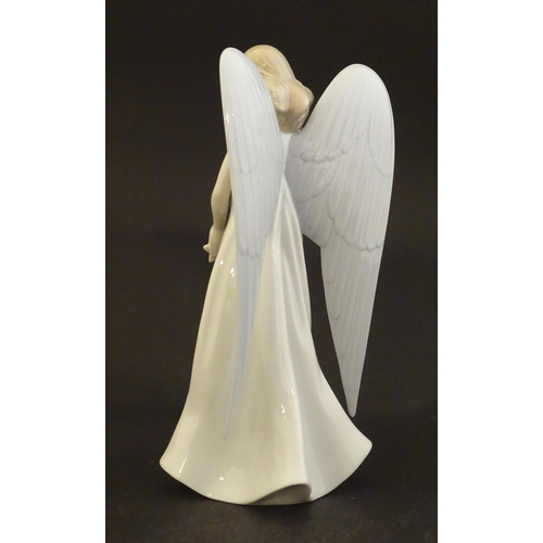 119 - A Lladro figure modelled as an angel with a box of stars, Angelic Star, model no. 8534. Marked under... 