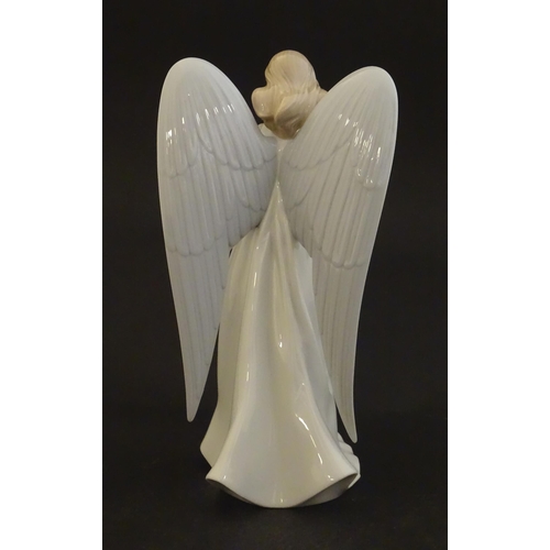 119 - A Lladro figure modelled as an angel with a box of stars, Angelic Star, model no. 8534. Marked under... 