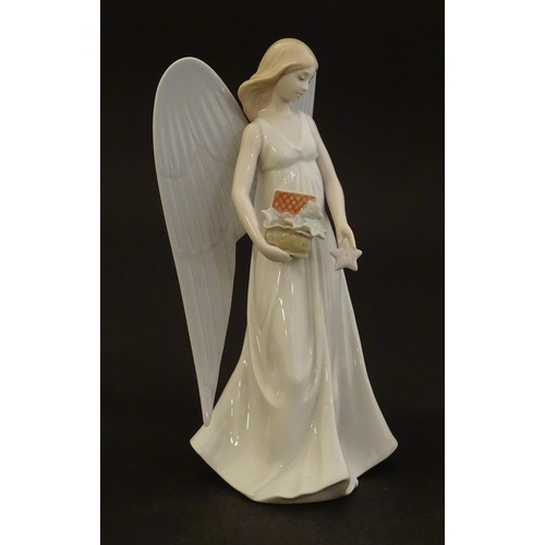 119 - A Lladro figure modelled as an angel with a box of stars, Angelic Star, model no. 8534. Marked under... 