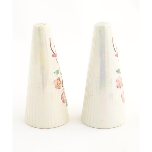 142 - A salt and pepper cruet of conical form with floral decoration by Maling. Marked under. Approx. 5