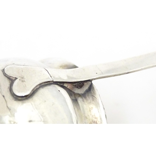 387 - A later 18th / early 19thC white metal toddy / punch ladle with a whale bone handle. Approx. 11 1/2