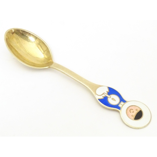 391 - Scandinavian silver: A Danish silver gilt and enamel childs spoon with Inuit decoration by A Michels... 