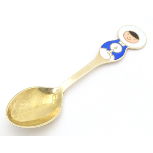 391 - Scandinavian silver: A Danish silver gilt and enamel childs spoon with Inuit decoration by A Michels... 