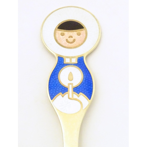 391 - Scandinavian silver: A Danish silver gilt and enamel childs spoon with Inuit decoration by A Michels... 