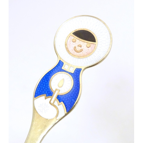 391 - Scandinavian silver: A Danish silver gilt and enamel childs spoon with Inuit decoration by A Michels... 