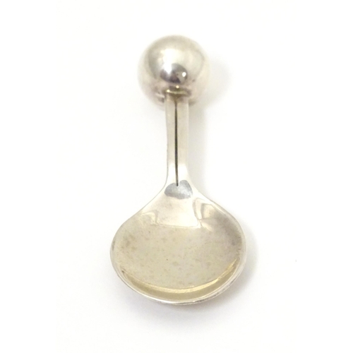 394 - A silver caddy spoon with spherical finial to handle, hallmarked London 2004, maker TPTE. Approx. 3