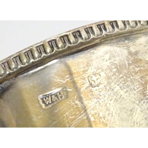 395 - A silver porringer with twin handles, hallmarked Birmingham 1925, maker Walker & Hall. Approx. 6