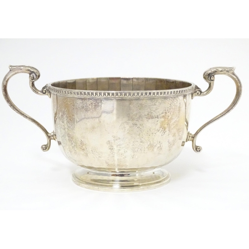 395 - A silver porringer with twin handles, hallmarked Birmingham 1925, maker Walker & Hall. Approx. 6