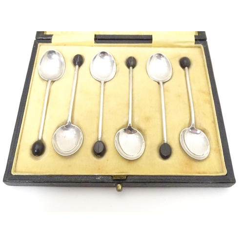 411 - A set of six silver coffee spoons the handles surmounted by coffee beans, hallmarked Birmingham 1924... 