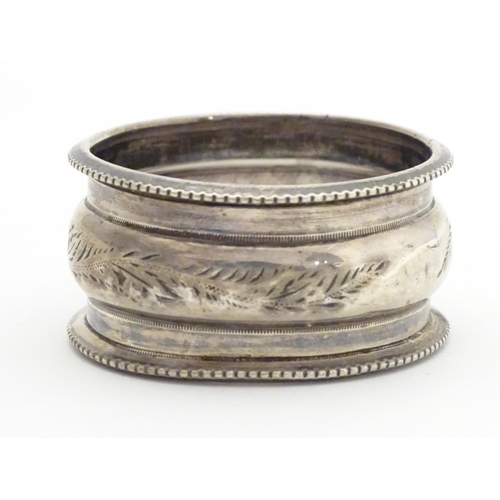 526 - A silver napkin ring hallmarked Birmingham 1900, maker Henry Hobson & Sons. Together with a Geo III ... 