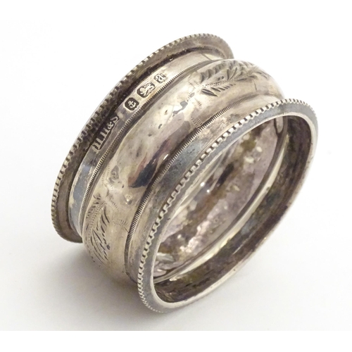 526 - A silver napkin ring hallmarked Birmingham 1900, maker Henry Hobson & Sons. Together with a Geo III ... 