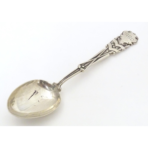 533 - A silver teaspoon the handle with gold club and ball decoration and engraved HGC, possible for Hamps... 