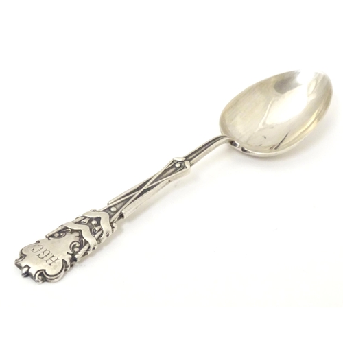 533 - A silver teaspoon the handle with gold club and ball decoration and engraved HGC, possible for Hamps... 