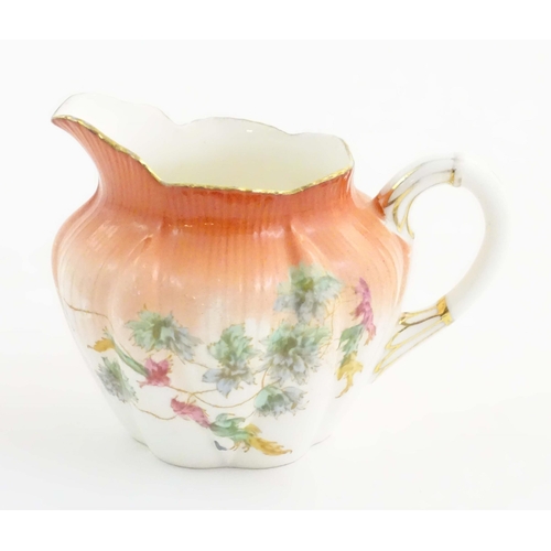 143 - A Wileman Foley China jug with floral and foliate detail. Marked under. Approx. 3 1/2