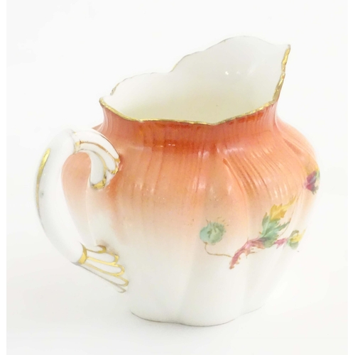 143 - A Wileman Foley China jug with floral and foliate detail. Marked under. Approx. 3 1/2