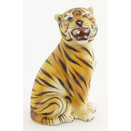 182 - A 20thC Continental model of a seated tiger. Marked under C. L. F. Faiancas Alcobaca Portugal. Appro... 