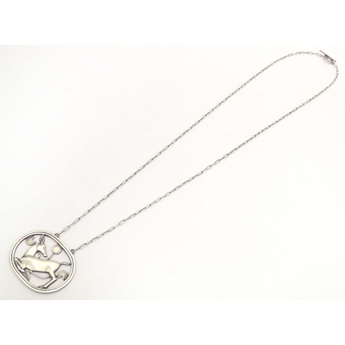 618 - Georg Jensen : A silver pendant necklace designed by Arno Malinowski depicting a kneeling deer. Stam... 