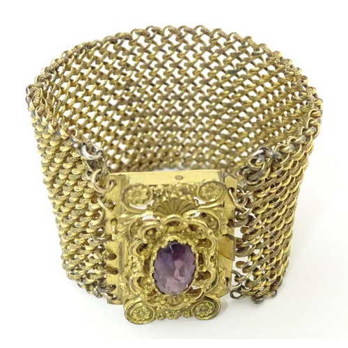 621 - A Victorian pinchbeck bracelet set with amethyst coloured paste stone. Approx 7 1/2