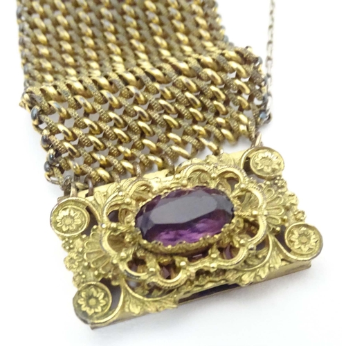 621 - A Victorian pinchbeck bracelet set with amethyst coloured paste stone. Approx 7 1/2