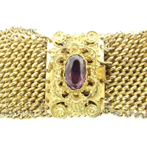 621 - A Victorian pinchbeck bracelet set with amethyst coloured paste stone. Approx 7 1/2