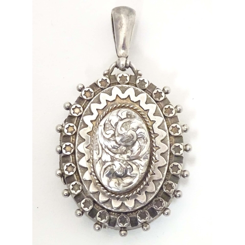 622 - A Victorian silver locket of pendant form with engraved decoration. hallmarked Birmingham 1886. Appr... 