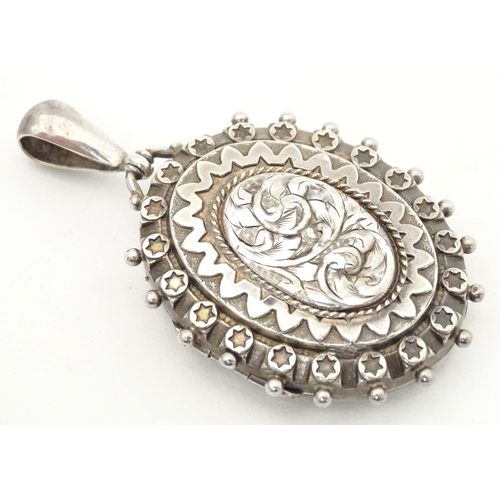 622 - A Victorian silver locket of pendant form with engraved decoration. hallmarked Birmingham 1886. Appr... 