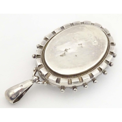 622 - A Victorian silver locket of pendant form with engraved decoration. hallmarked Birmingham 1886. Appr... 