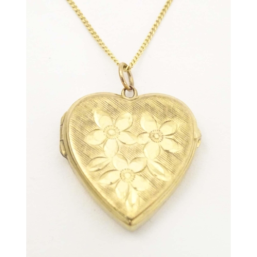 633 - A 9ct gold pendant locket of heart form by  Georg Jensen Ltd. With 9ct gold chain 18