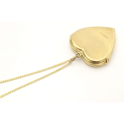 633 - A 9ct gold pendant locket of heart form by  Georg Jensen Ltd. With 9ct gold chain 18