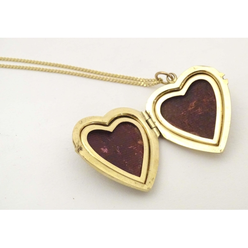 633 - A 9ct gold pendant locket of heart form by  Georg Jensen Ltd. With 9ct gold chain 18