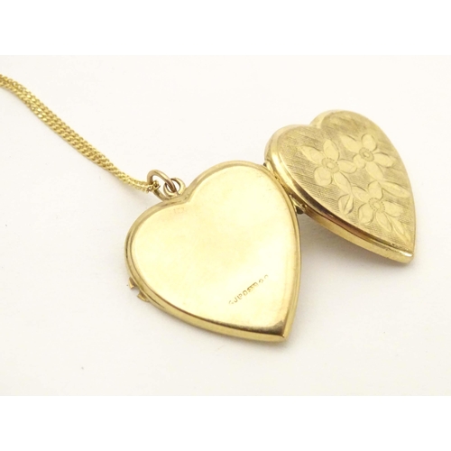 633 - A 9ct gold pendant locket of heart form by  Georg Jensen Ltd. With 9ct gold chain 18