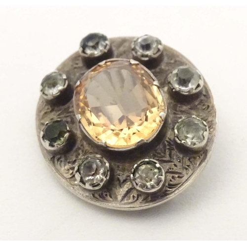 635 - A white metal brooch set with central citrine bordered by white stones. 1